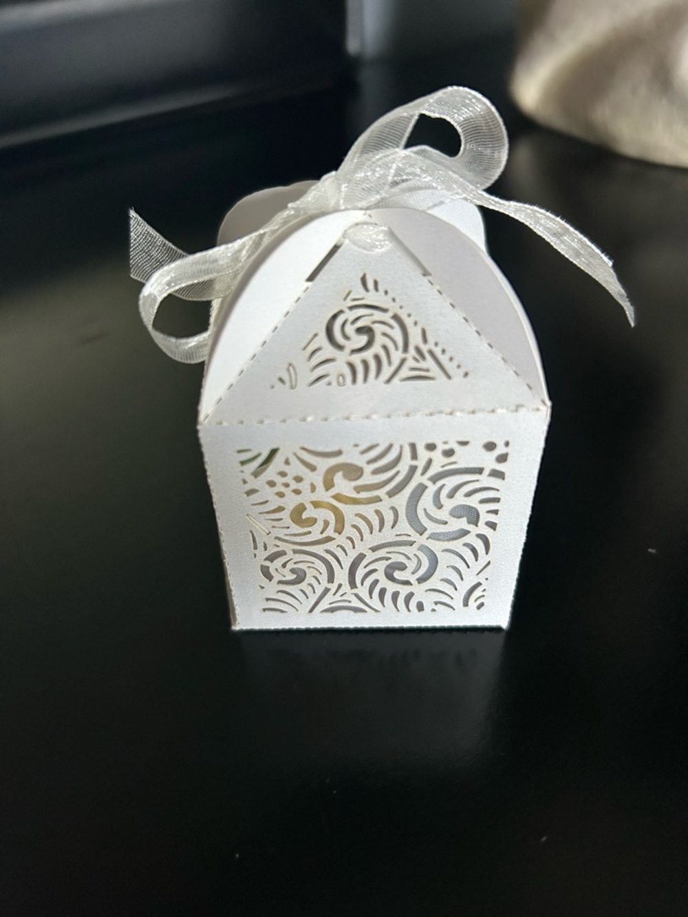 White Laser-Cut Favor Box with Ribbon filled with Jordan almonds.